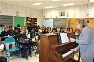 music teacher playing piano note and coaching class 